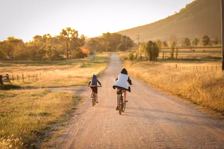 children riding bikes remote country lane