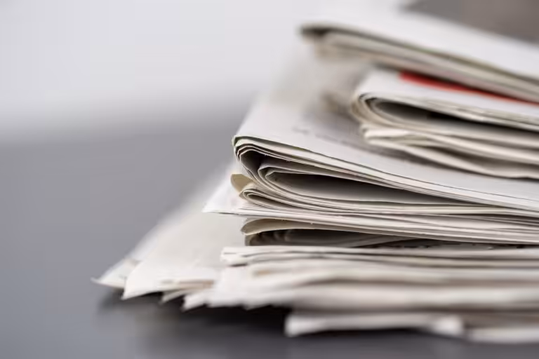 closeup shot several newspapers stacked top each other