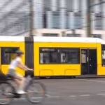 yellow tram cyclist urban transport motion dynamic intersection 1