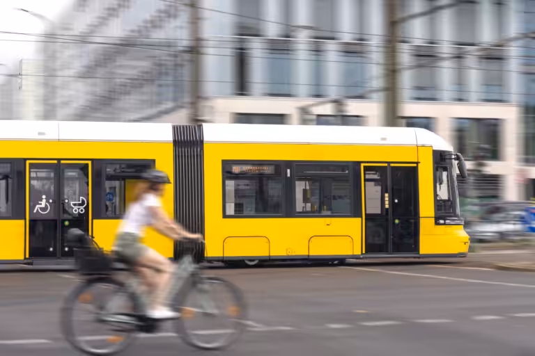 yellow tram cyclist urban transport motion dynamic intersection 1